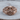 Helmet Winged Skull Ring, rose gold, front product view on wood