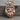 Mountain Bear Paw Pendant, rose gold, product photo on wood surface