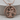 Sagittarius Zodiac Medallion Pendant, rose gold, front view on wood base