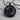 Koi Lotus Medallion Pendant, black rhodium, product photo on wood block