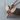 Winged Arrow Pendant, rose gold, angled view on wood block