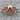 Tribal Biker Skull Ring, rose gold, front view on wood surface