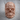 Baroque Foliage Skull Ring, rose gold, front view on wood