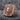 Lion Eagle Signet Ring, rose gold, angled view on rock surface