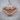Armored Viking Skull Ring, rose gold plated, front view on wood background
