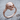 Skeleton Hand Skull Ring, rose gold, angled view on wood