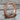 Greek meander hoop earring, black rhodium plated, product photo on stone
