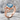 Blue Topaz Ribbon Loop Ring, rose plated silver, angled studio view
