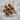 Garnet Seven Stone Rosette Ring, rose gold plated, angled studio view