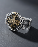 Men's silver knight cross ring with gold-plated accents on the cross and bezel, shown on a dark slate background.