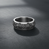 Silver lunar crater ring with oxidized finish and rugged moon texture displayed on slate surface