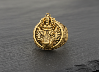 Front view of gold vermeil crowned lion ring handcrafted in 925 sterling silver on dark stone background