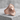 Sun Archer Ring, rose gold, angled view on stone base