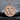 Double Venus Medallion Pendant, rose gold, front view on stone surface