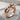 Women Embracing Ring, rose gold, front product photo on stone