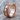 Skull Smoke Ring, rose gold, product photo resting on stone