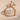 Two Giraffes Ring, rose gold, front view on sand