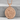 Dragon and Phoenix Medallion Pendant, rose gold plated, front view on stone pedestal