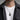 Man wearing an oxidized silver lion head pendant on rope chain with white tshirt and gray overshirt