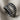 Shark Jaw Teeth Ring, oxidized, front view on textured fabric