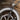 Close-up detail of handcrafted crowned skeleton figure and engraved N letter on oxidized silver spinner pendant