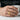 Superhero emblem ring in gold vermeil, worn on model hand