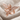 Praying Cherub Ring, rose gold, angled front view on fabric