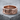 Interlocking Hearts Ring in rose gold, front view on stone surface