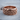 Spiral Wave Ring, rose gold, angled view on wood slice