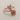 Rose bypass ring in rose gold finish, product photo on fabric