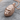 Calm Gorilla Head Pendant, rose gold, angled product photo on wood