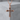 Black Cross Pendant, rose gold, front view on stone pedestal