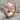 IC XC Nika Ring, rose gold finish, angled product photo on stone