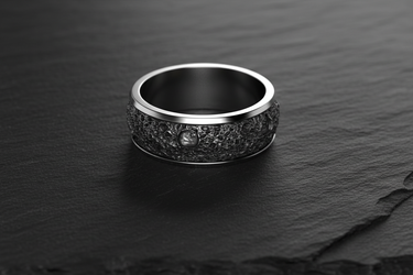 Close up of 925 sterling silver band ring featuring detailed crater texture and smooth inner band