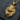 Close-up of magnificent gold lion head pendant with intricate crown detail resting on a dark gray textured surface.