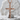 Rustic Latin Cross Pendant in rose gold, front view on stone display