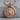 Lion Medallion Pendant, rose gold finish, product photo on stone