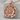 Tudor Rose Pendant, rose gold, front view on stone display