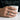 Hand wearing oxidized silver shard blade ring holding a white mug in a modern lifestyle setting