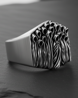 Side profile of the Silver Ghost Ring showcasing the smooth, wide band and the depth of the sculpted phantom crowd.
