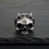 Front view of 925 sterling silver devil skull ring featuring textured horns and oxidized finish on black stone background