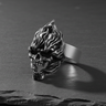 Angled view of 925 sterling silver flaming skull ring showing oxidized finish and sculpted fire elements
