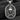 Close-up of 925 sterling silver skull crown pendant with crossed bones and wreath on dark textured wood