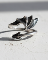 Side view of open shank silver ring showing webbed wing design and oxidized finish