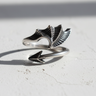 Side view of open shank silver ring showing webbed wing design and oxidized finish