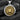 Gold plated silver lion pendant for men displayed on dark charcoal background for contrast