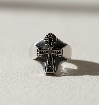 Front view of Ankh cross ring design featuring pavé set black stones on sterling silver base