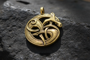 Detailed Norse wolf pendant design featuring mythical beast biting its tail in Urnes style knotwork