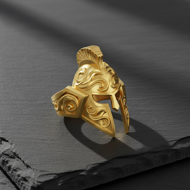 14K gold vermeil Spartan helmet ring with ornate filigree engravings showcased on a dark, textured slate surface.