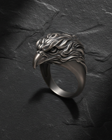 Side profile of oxidized silver eagle ring showing fierce eye detail and swept-back feather design